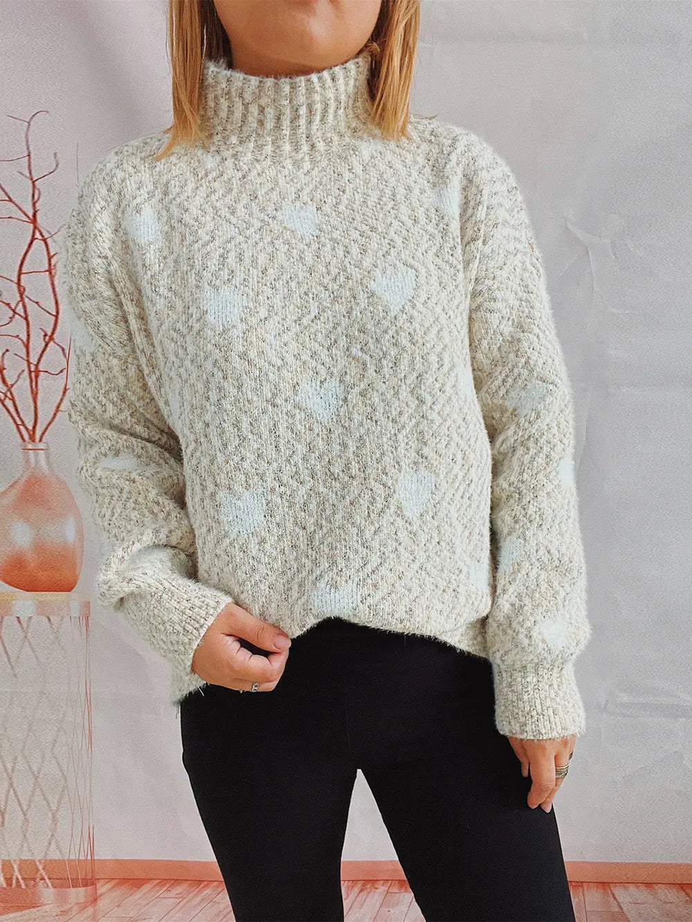 Heart-patterned heathered cream turtleneck drop-shoulder sweater, front view