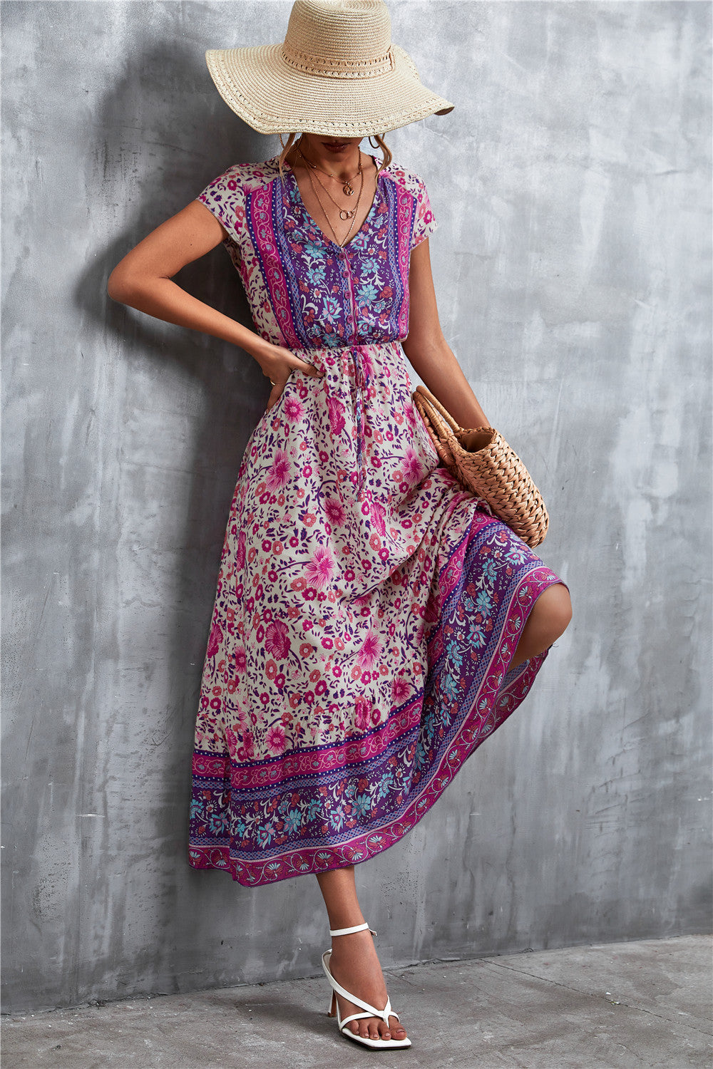 V-neck printed maxi dress with short sleeves, purple base with pink floral print and border.