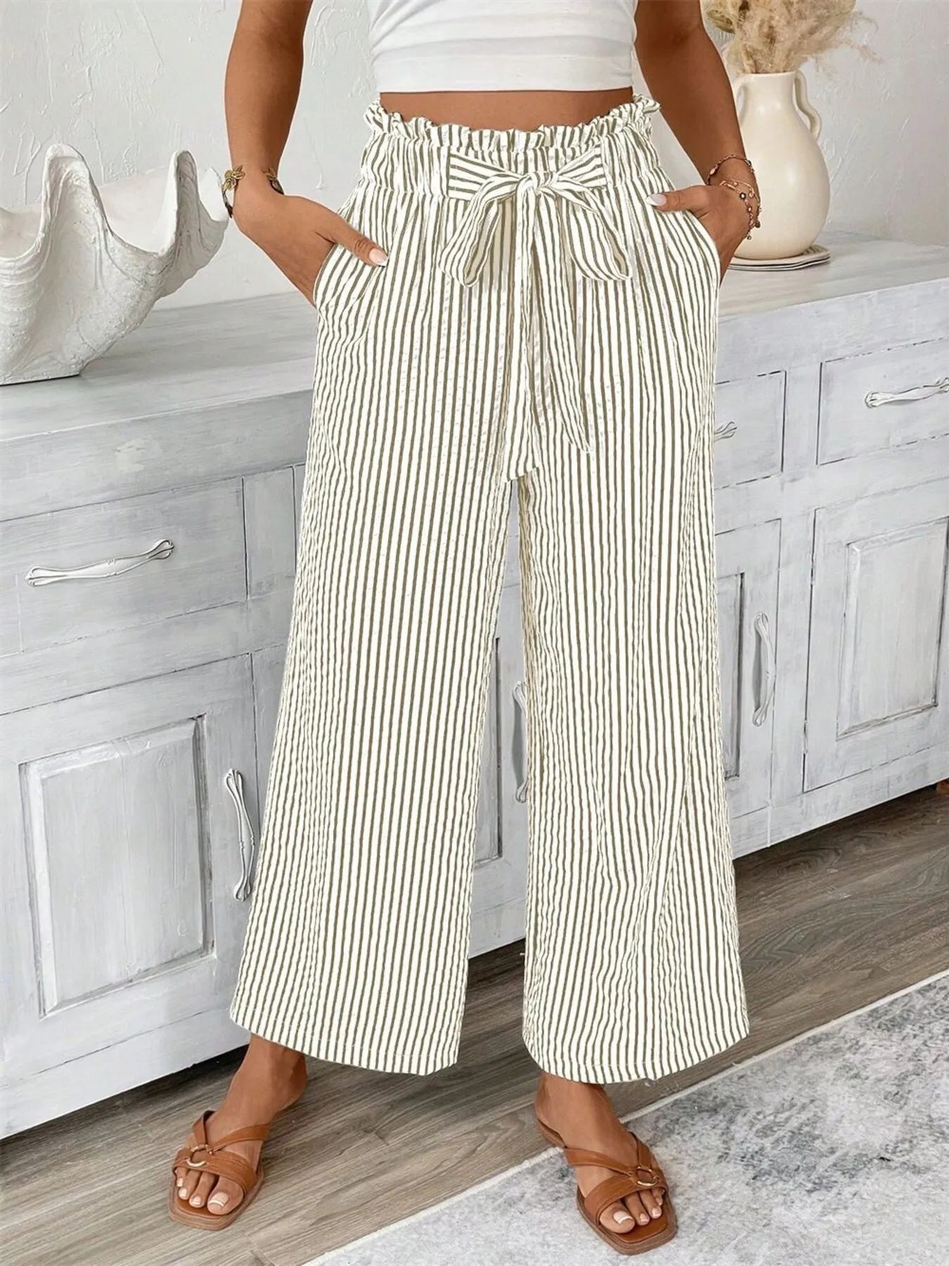 Striped wide-leg paper bag pants, cream with thin dark vertical stripes and tie waist