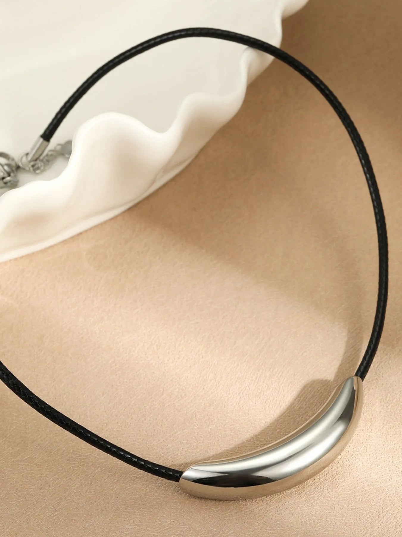 Curved bar pendant necklace with black leather rope and silver finish