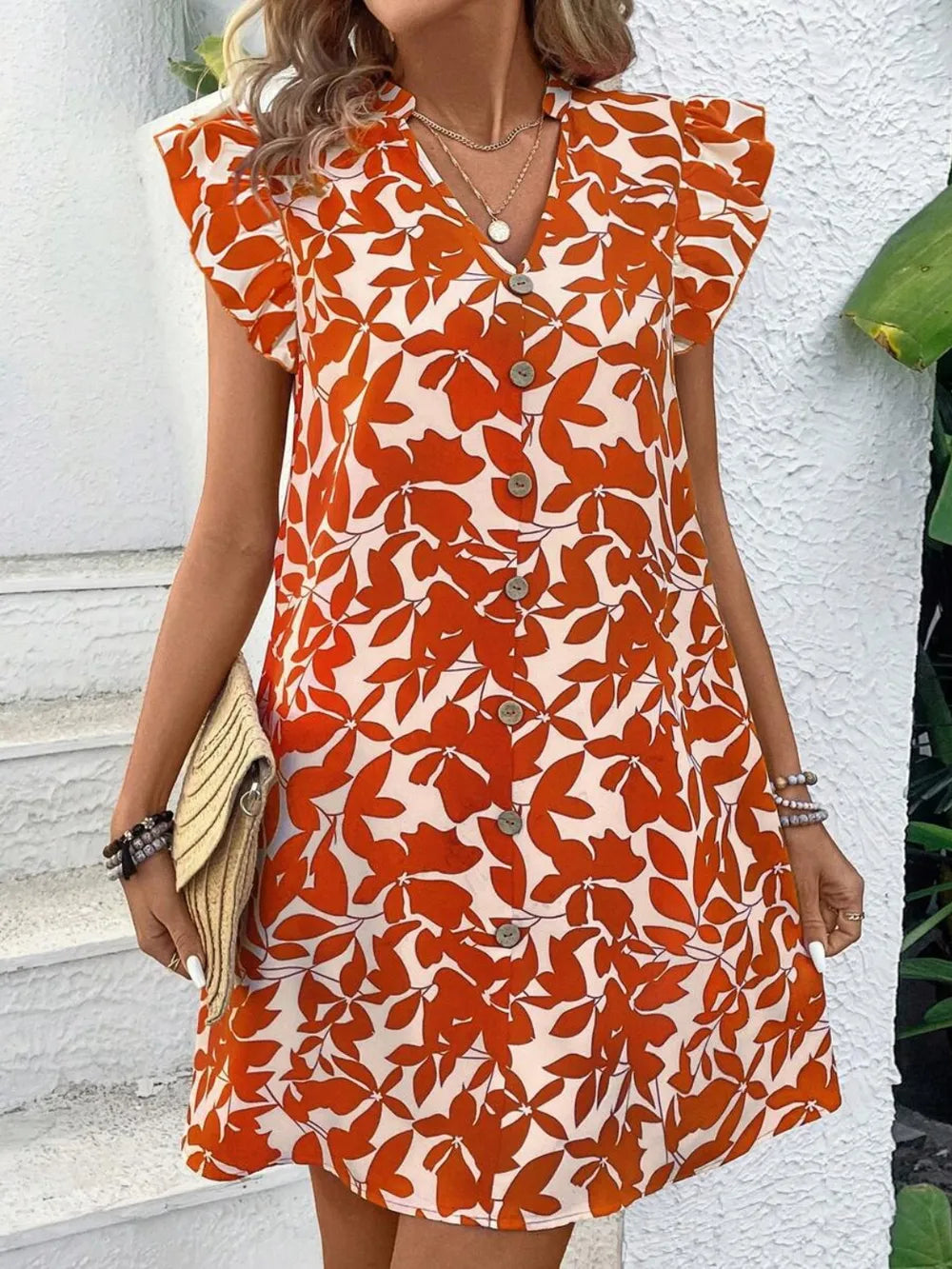 Printed notched cap-sleeve mini dress in orange floral pattern with front buttons