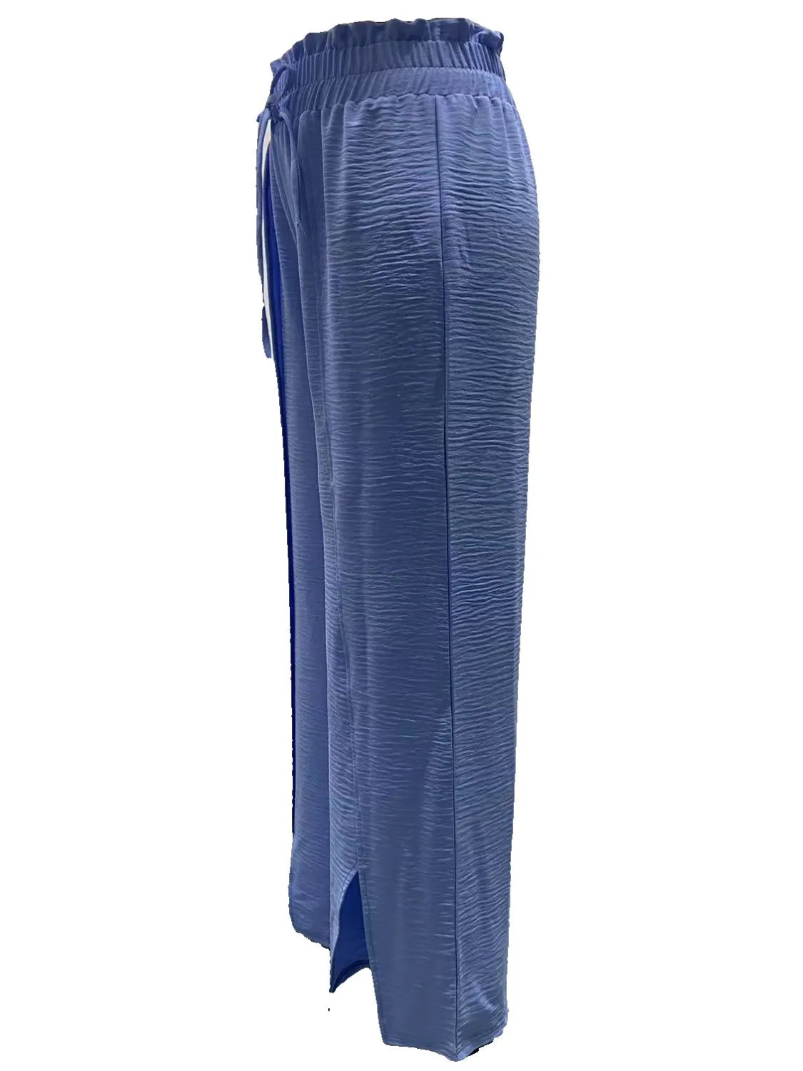 Dusty blue slit wide-leg pants shown from the side with side slit detail