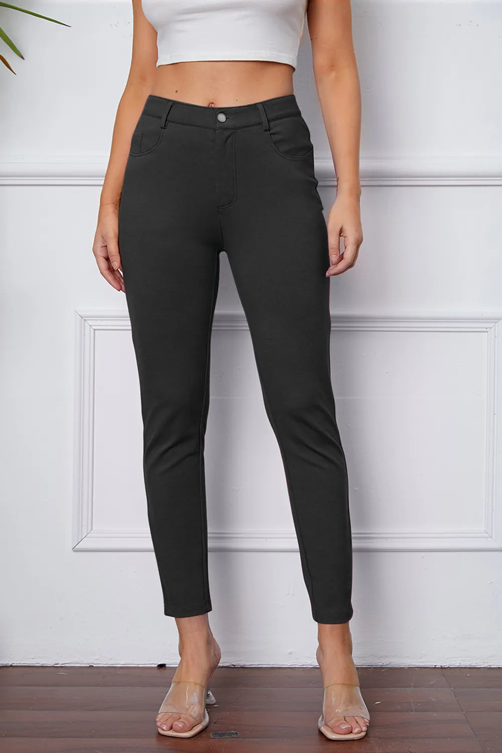 Dark slim ankle pants with belt loops, button front, and side pockets