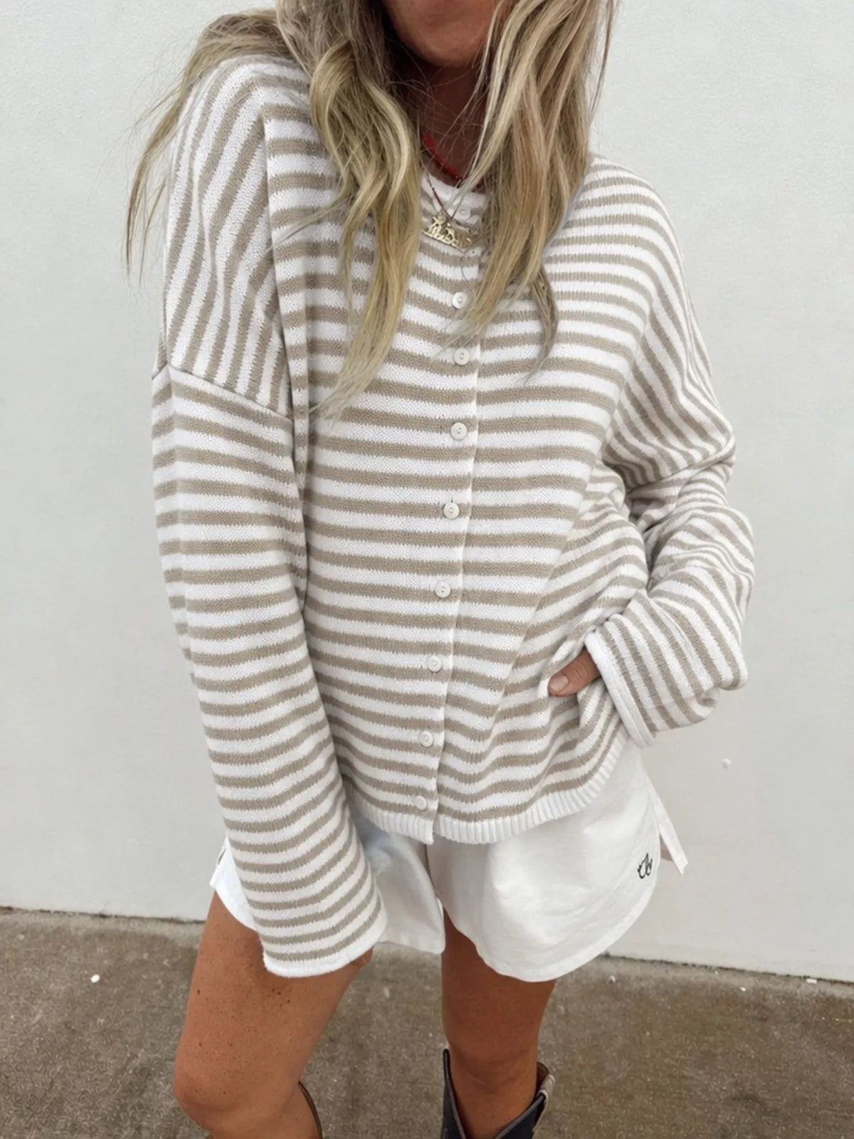 Beige and white striped knit cardigan with button front and long sleeves