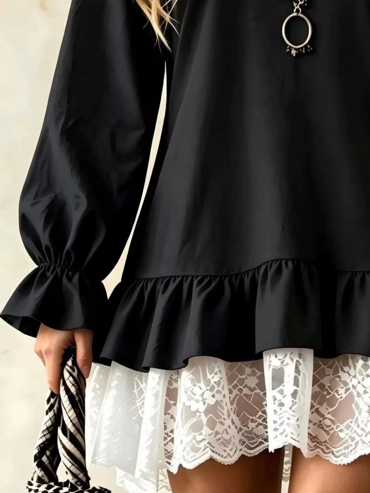 Black long-sleeve mini dress with lace-trim ruffle hem and gathered puff cuffs