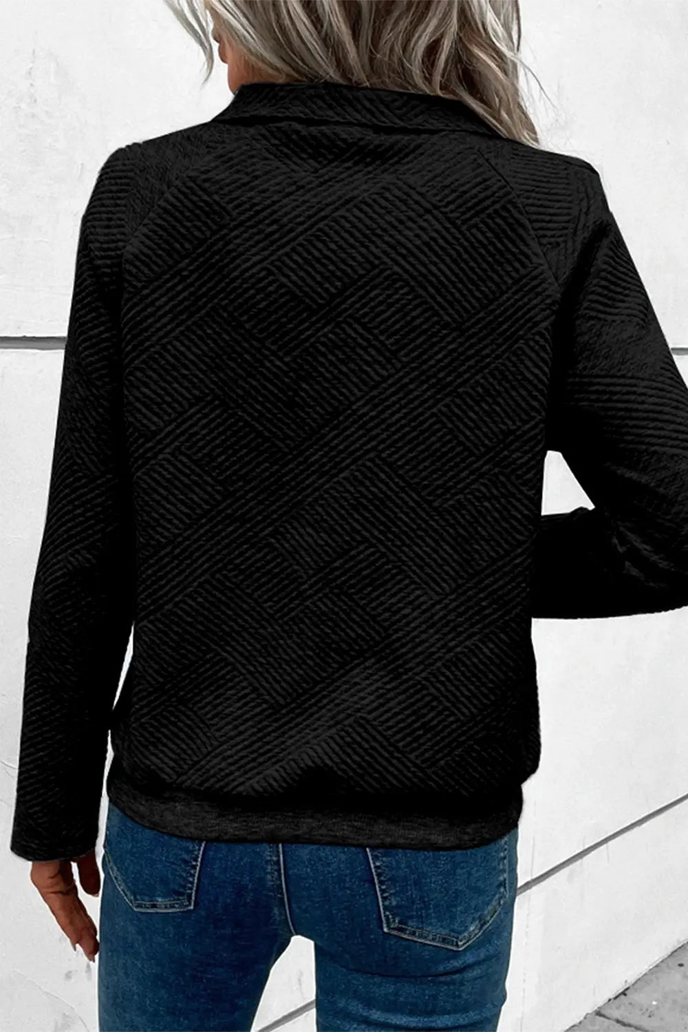 Black long-sleeve sweatshirt with geometric textured pattern and snap-button placket