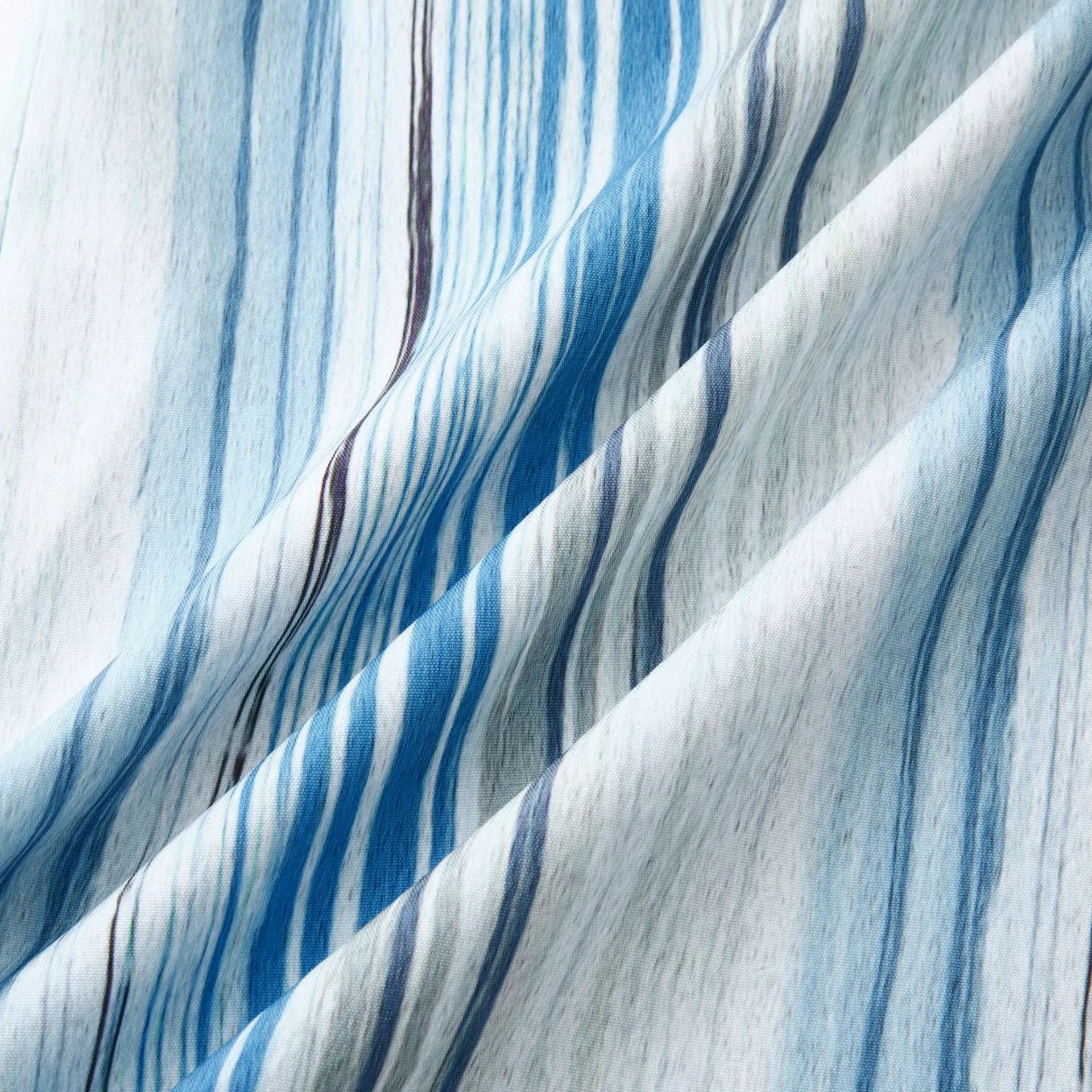 Striped button-up fabric with vertical pastel blue lines on white, soft drape