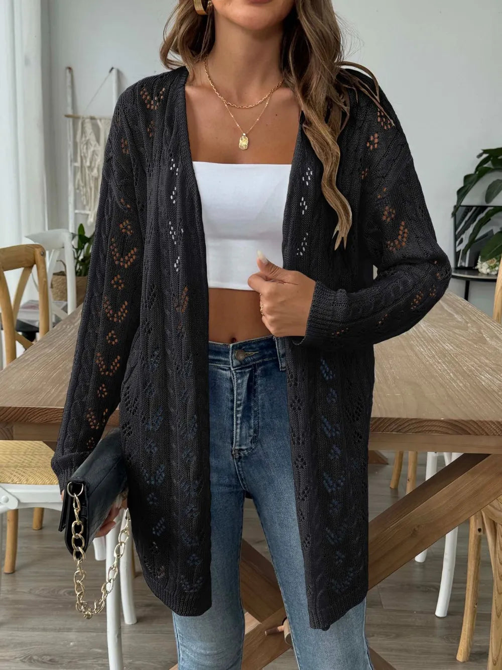 Black open-front long-sleeve cardigan with lace openwork knit pattern.