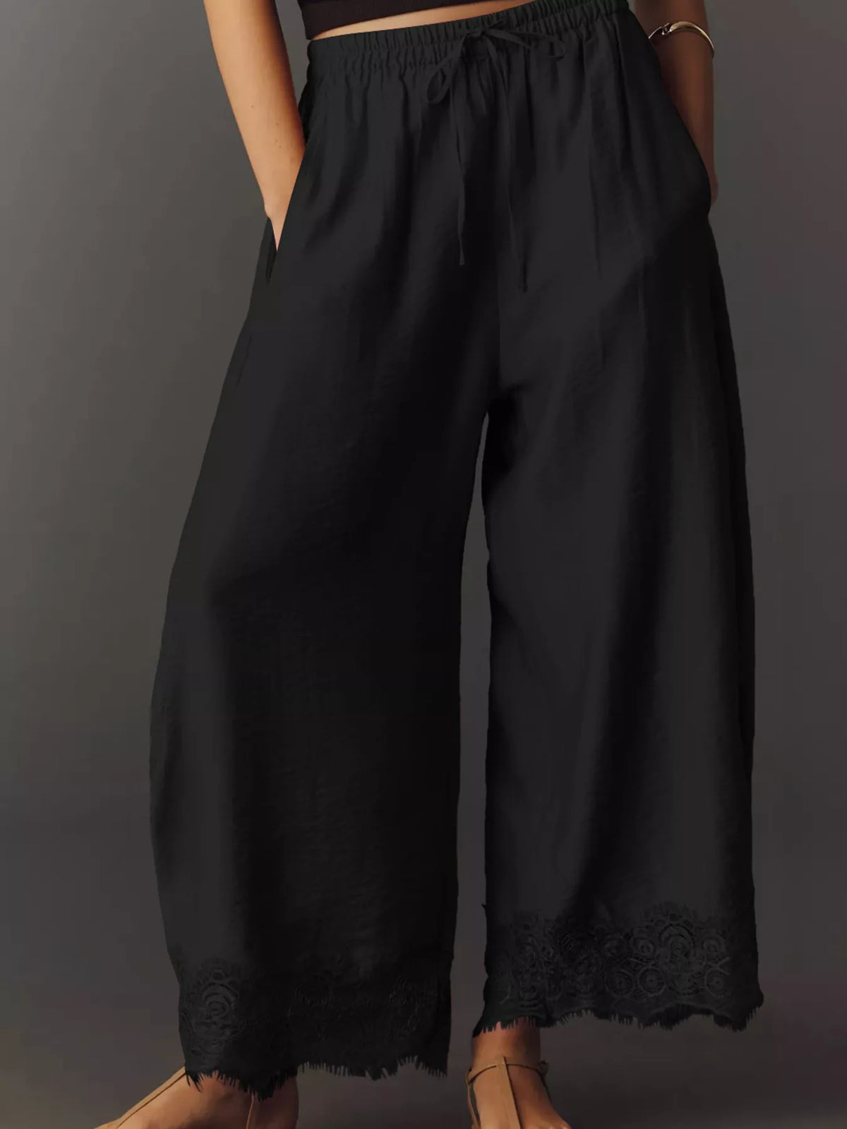 Black wide-leg drawstring pants with lace-trim hem