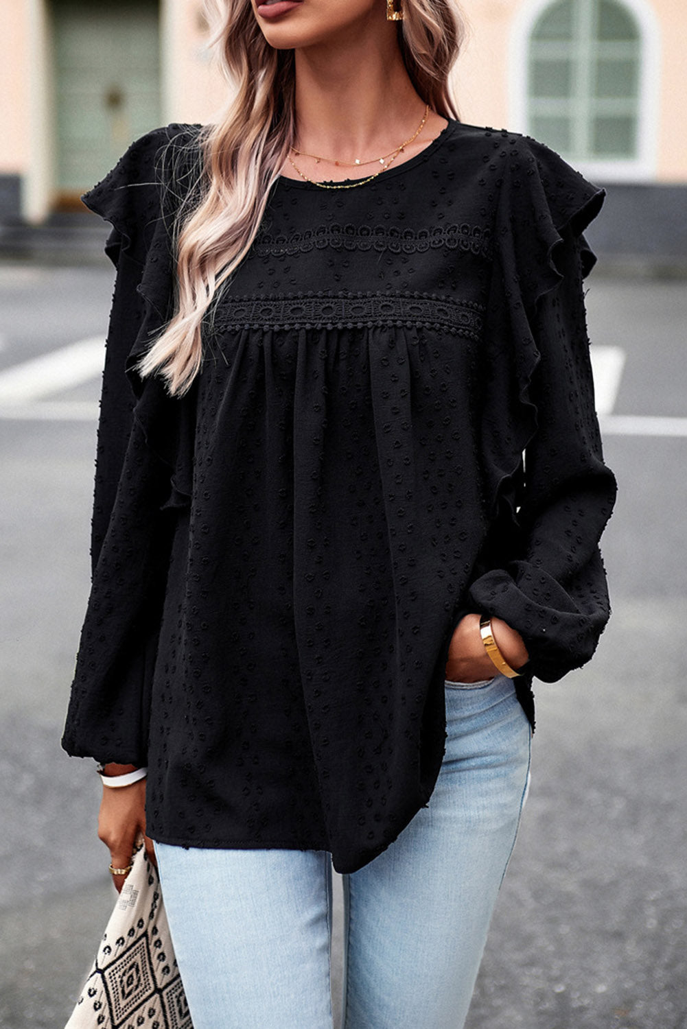 Ruffled round-neck blouse in black with long sleeves and tiered ruffle front