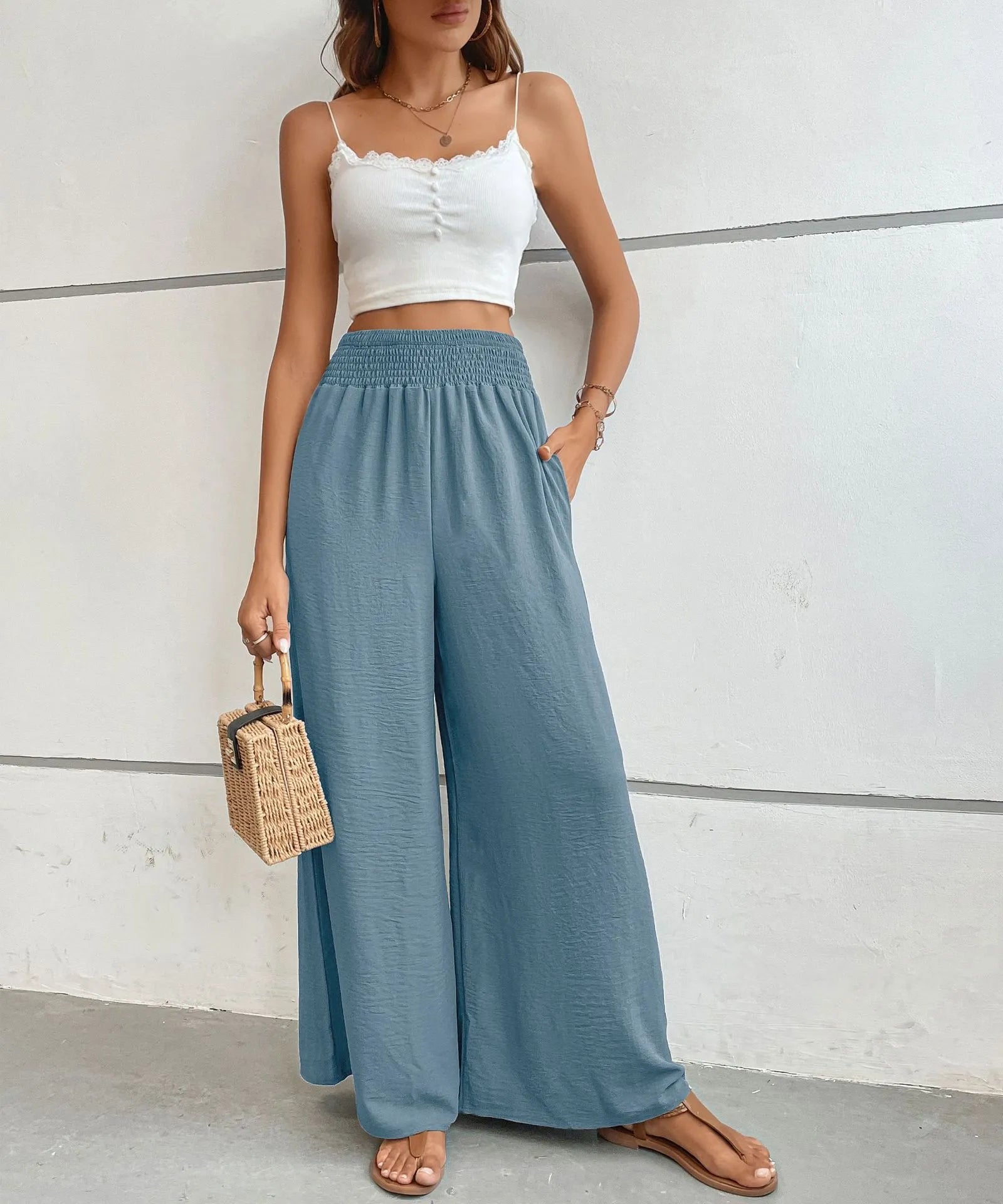 High-waisted wide-leg pants in dusty blue with smocked elastic waist and wide flared fit