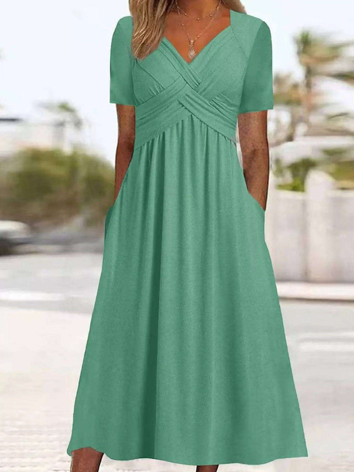 Green high-waist midi dress with crisscross wrap bodice and short sleeves