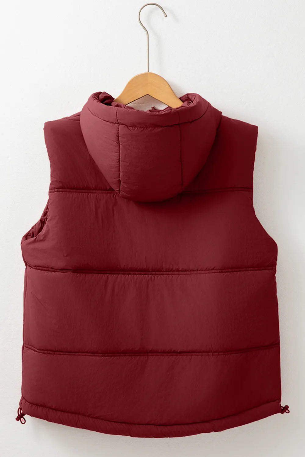 Burgundy hooded puffer vest coat back on hanger with drawcord hem and quilted panels