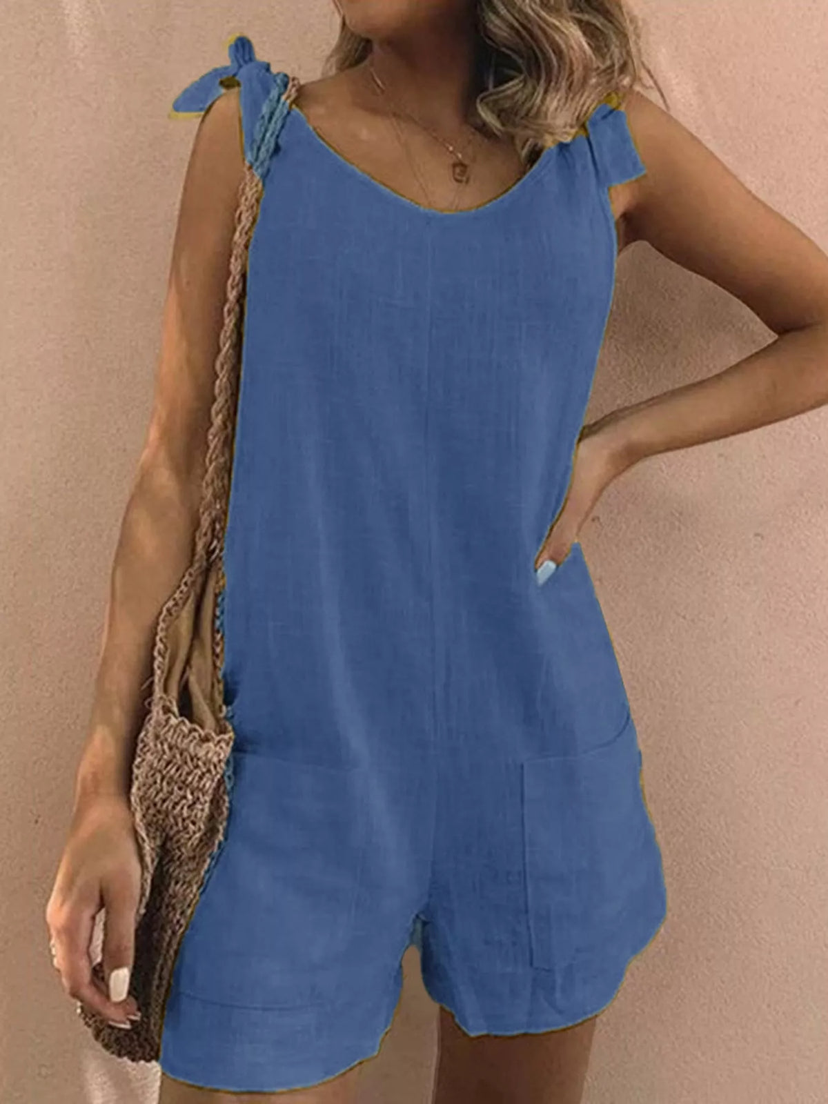 Blue tie-shoulder bow romper with front pockets and short, mid-waist wide legs