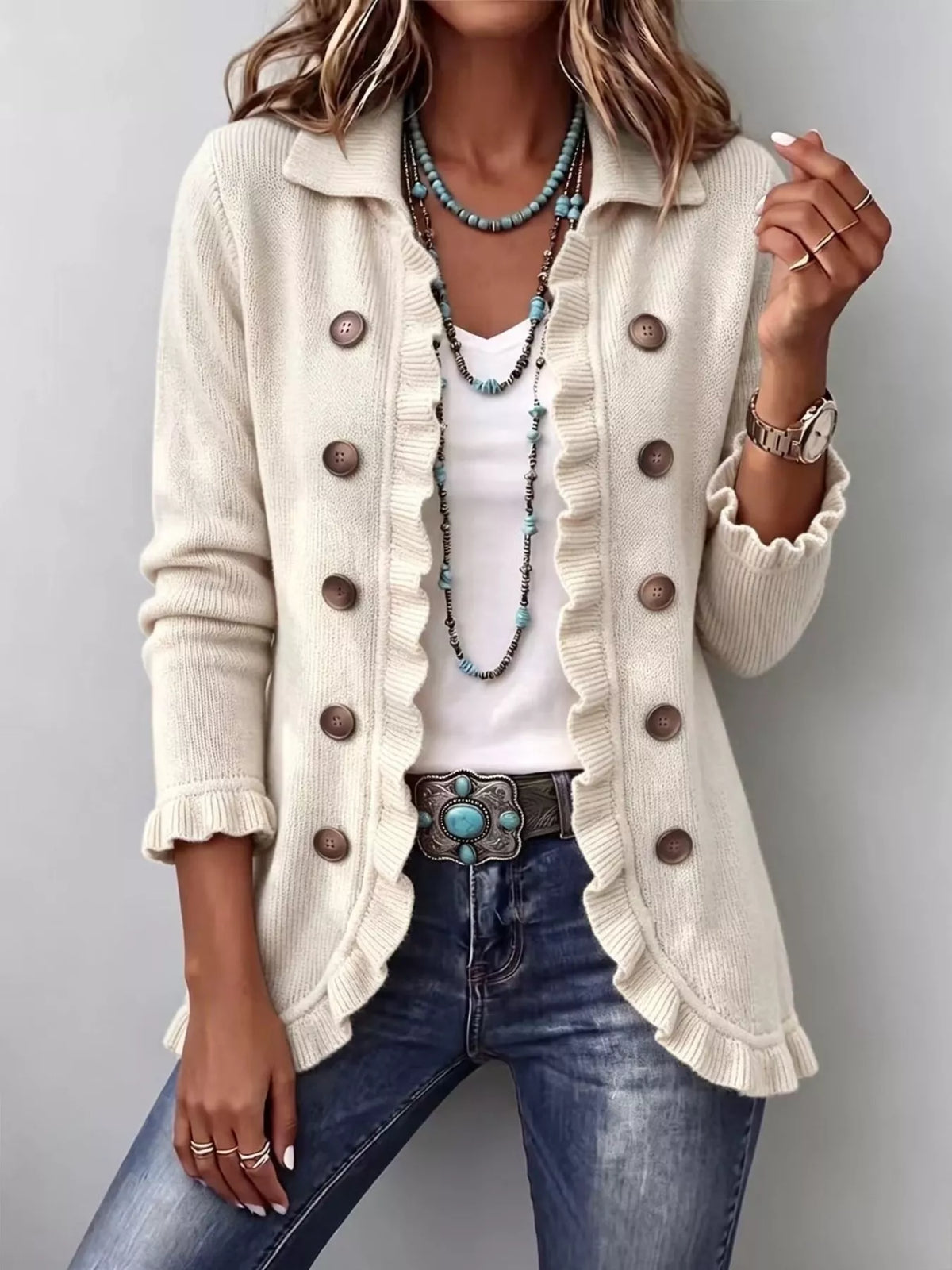 White ribbed ruffle button-up cardigan sweater with round front buttons and ruffled edges