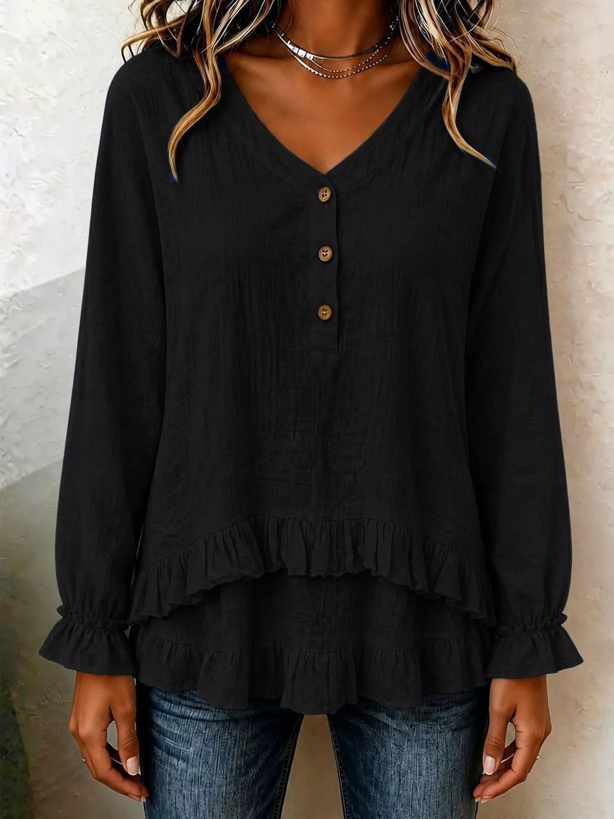 Black v-neck long-sleeve blouse with button front and ruffled tiered hem