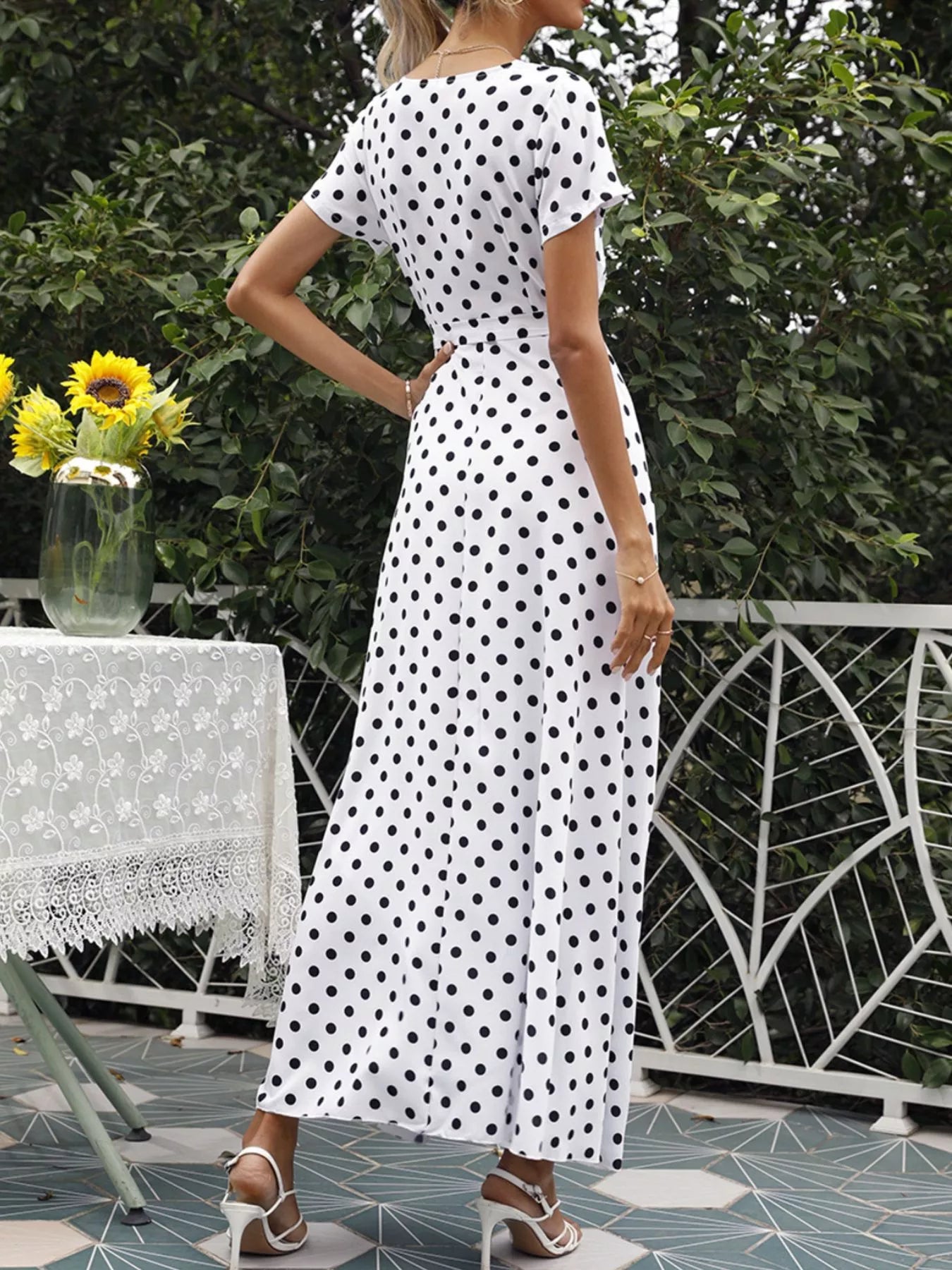 Polka-dot wrap maxi dress with belt, white with black dots, back view, waist tie, flowing skirt