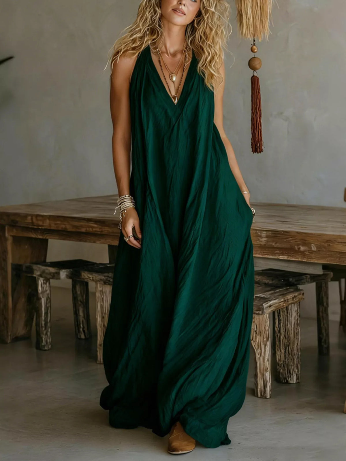 Dark green sleeveless V-neck flowy maxi dress with relaxed, draped skirt