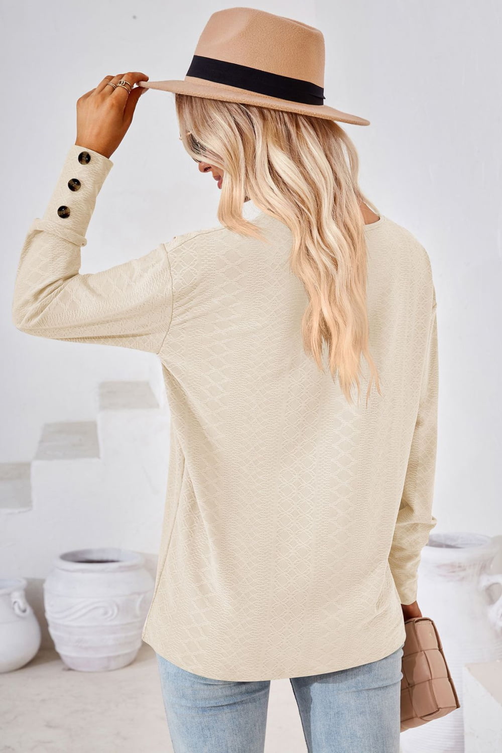 Cream V-neck long-sleeve blouse back view with diamond texture and buttoned cuffs