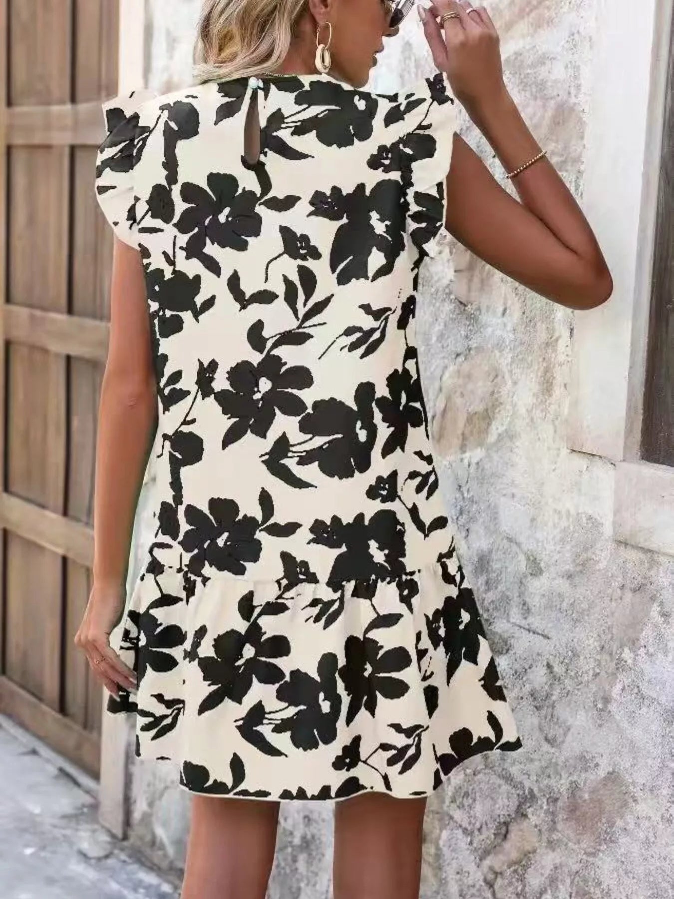Cream mini dress with black floral print, ruffle sleeves, and back view