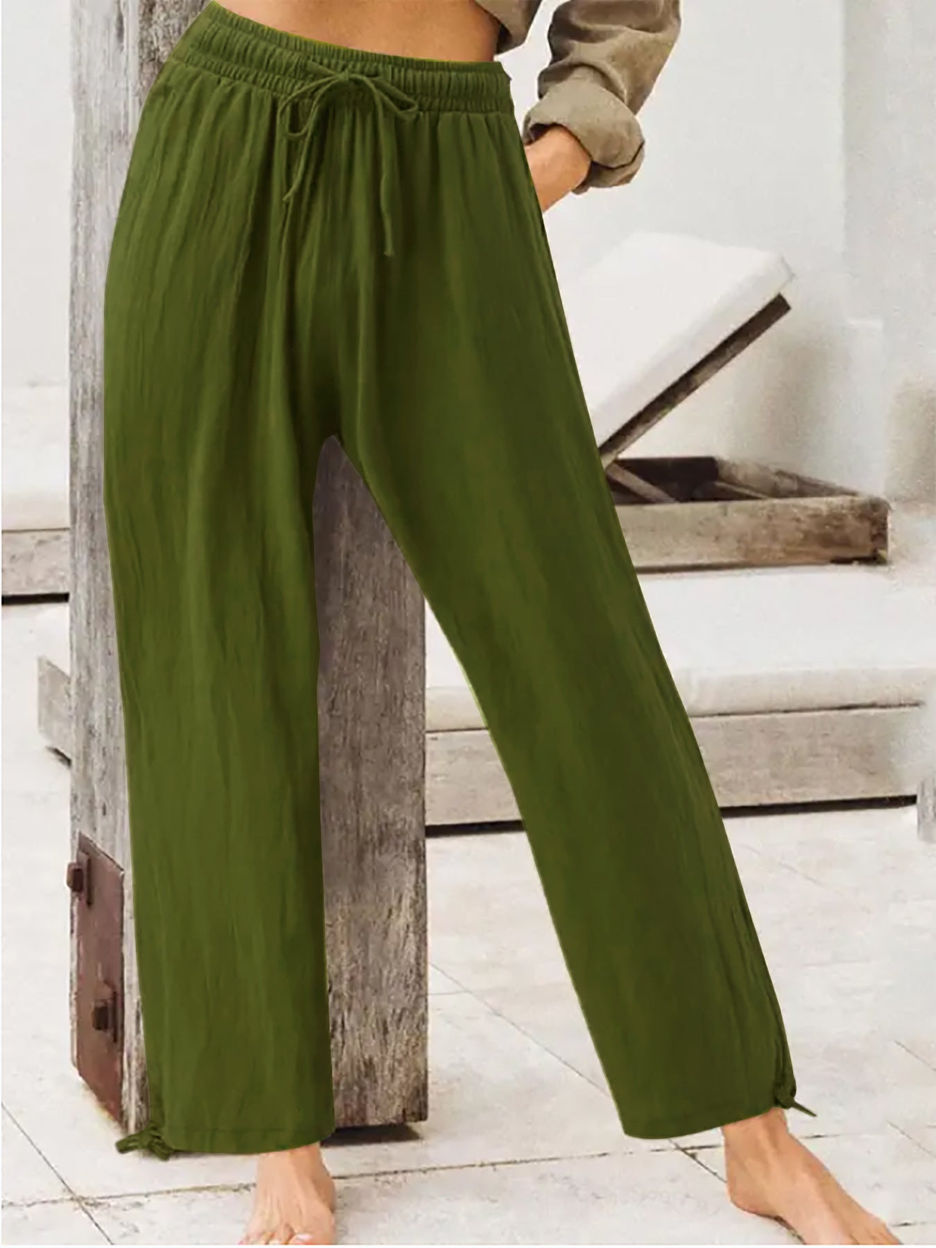 Olive green wide-leg drawstring pants with elastic waist and relaxed flowy legs