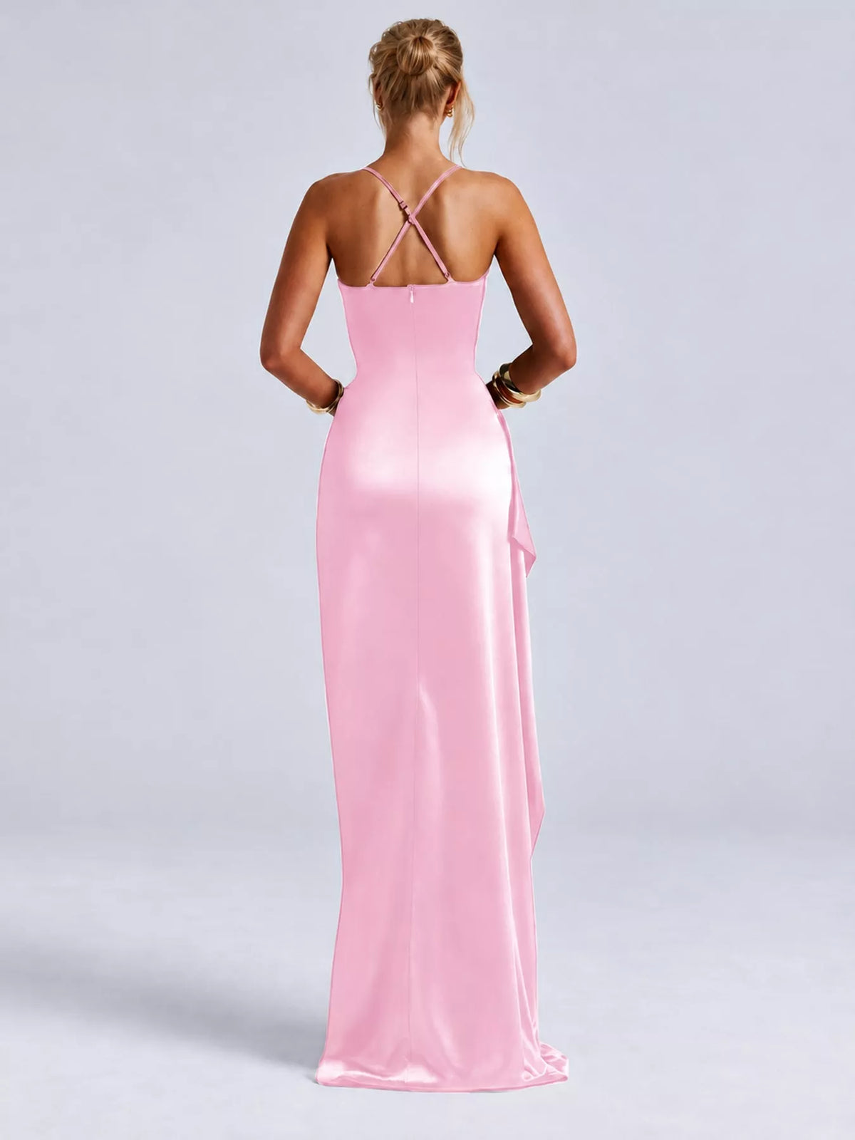 Pink satin maxi dress with ruched bodice and crisscross open-back straps, high side slit.