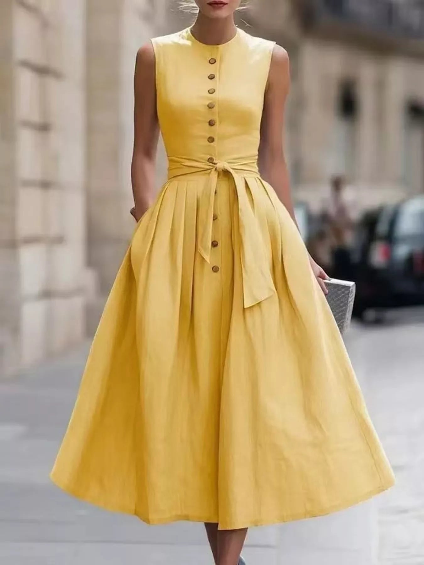 Yellow sleeveless midi dress with button front, ruched waist tie belt, gathered skirt.