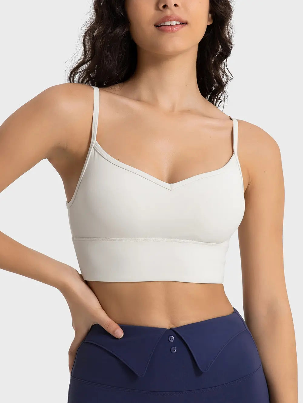Ivory spaghetti strap sport bra with V-neck front and smooth band