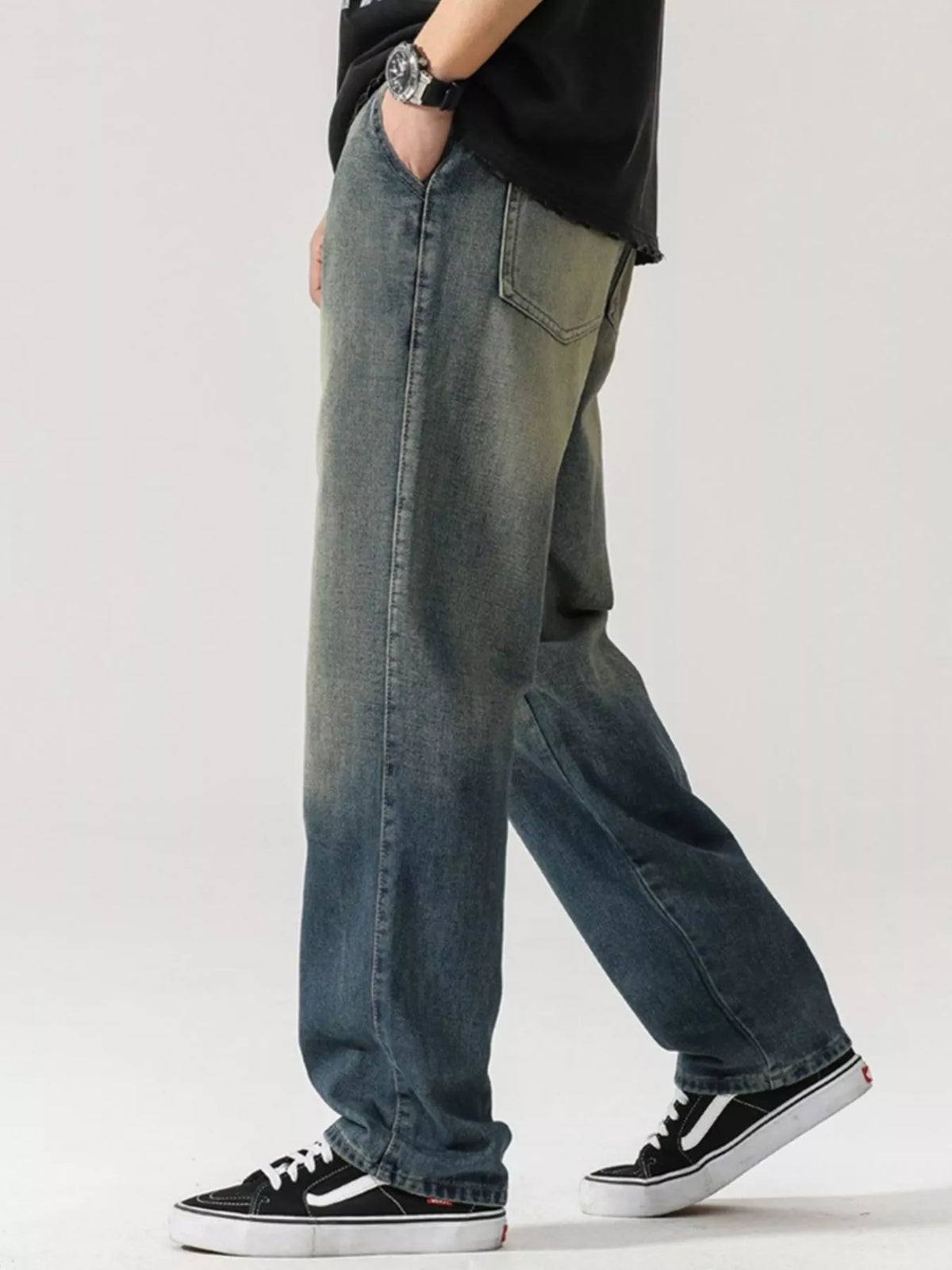 Men's washed teal denim jeans with wide-leg cut and side pockets