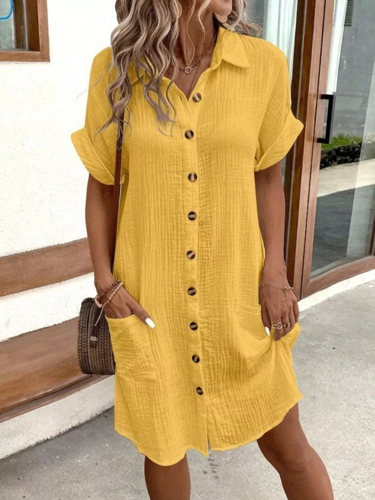Yellow textured button-front shirt dress with collar, short sleeves, and side pockets