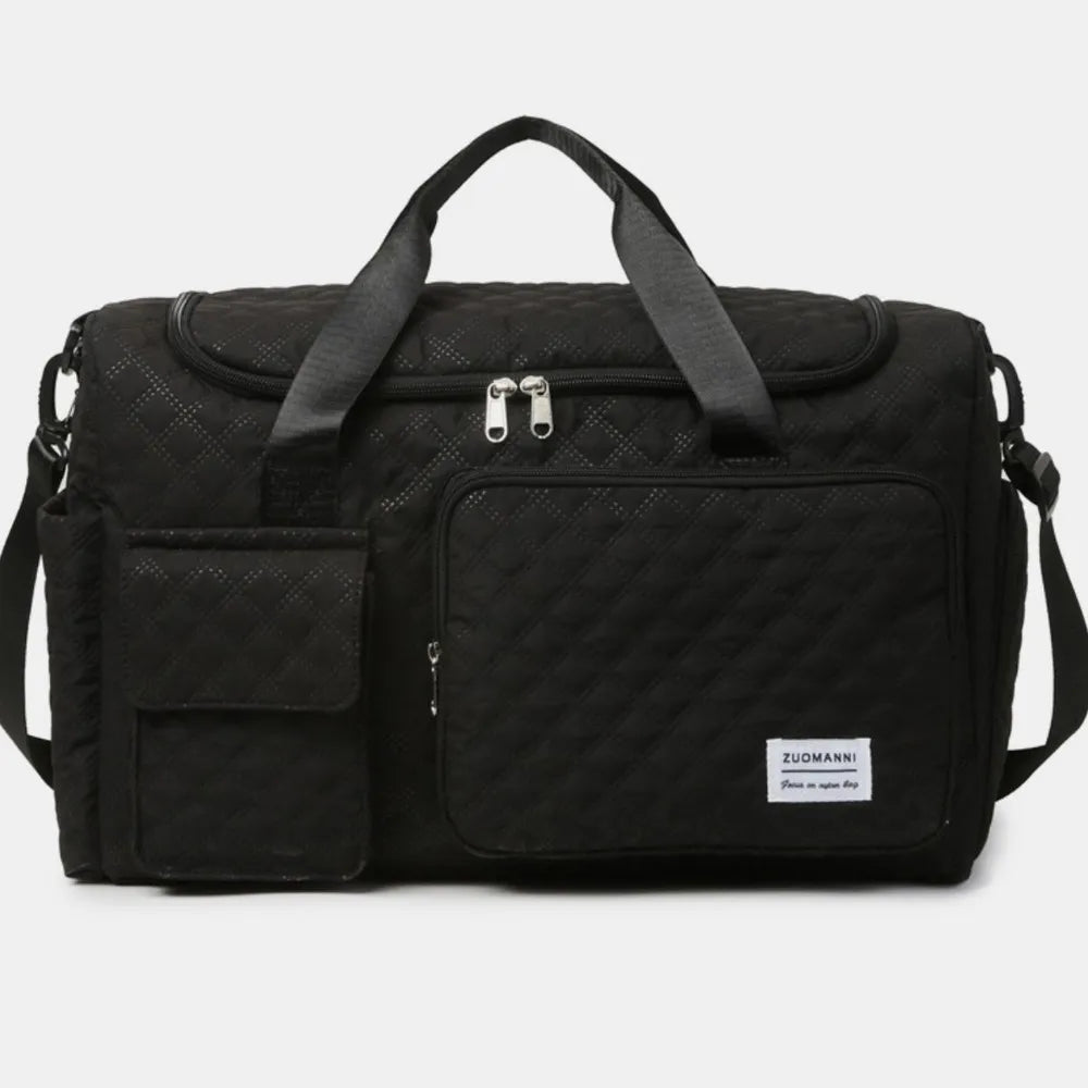 Black duffel travel bag with front zip pocket, padded handles, and crossbody strap