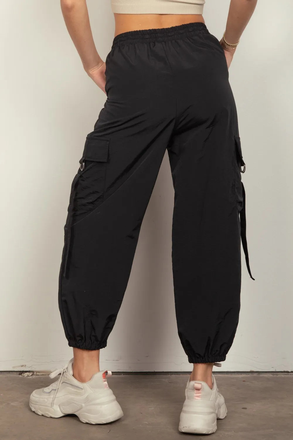 Black elastic-waist woven cargo pants with drawstring hem and side pockets