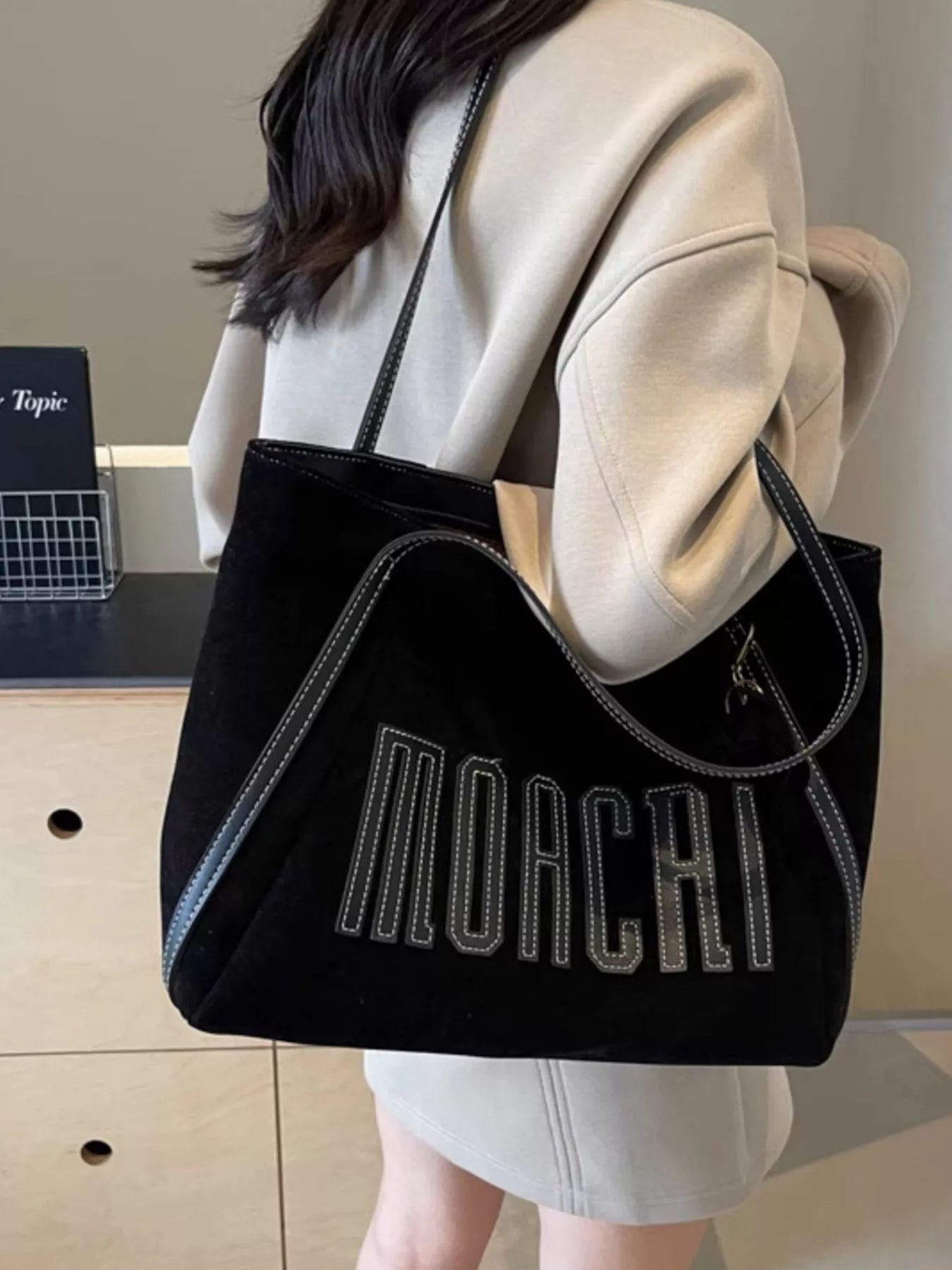 Casual Letter Shoulder Bag in black with white stitched MOCCA lettering, medium size.