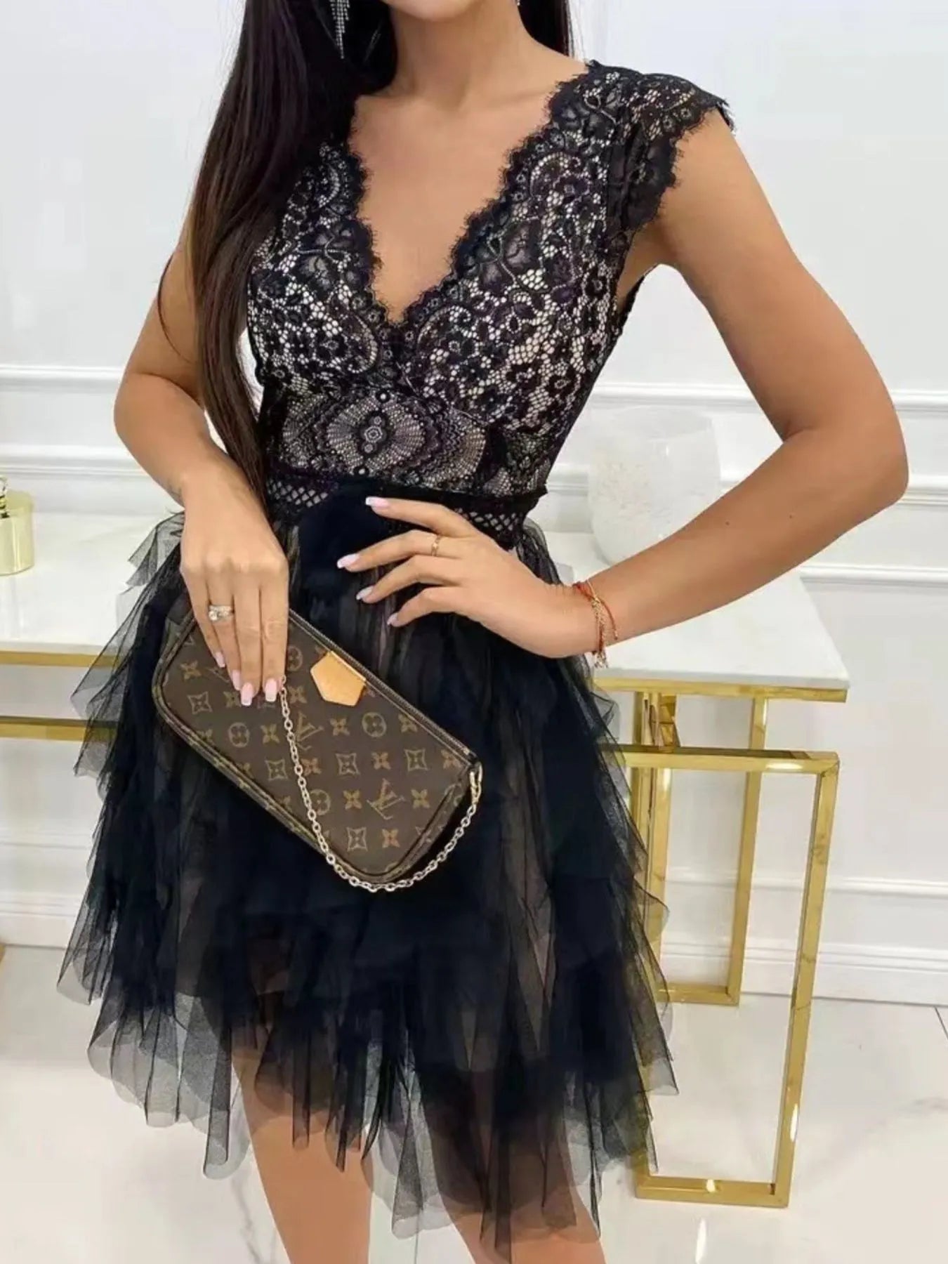 Black Lace V-Neck Ruffle Dress with tiered tulle skirt; model with Louis Vuitton clutch