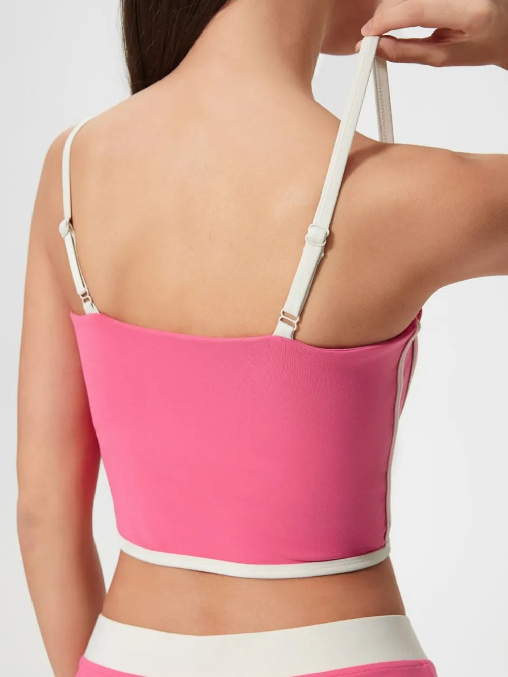 Back view of fuchsia pink active cami with contrast white trim and wide adjustable straps