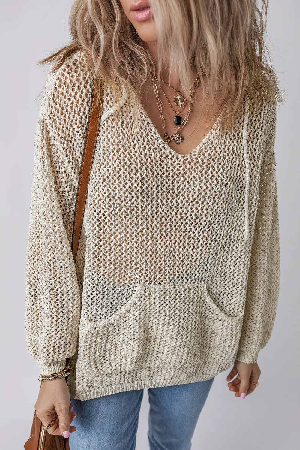Beige openwork knit hooded top with textured mesh stitch and front pouch pocket