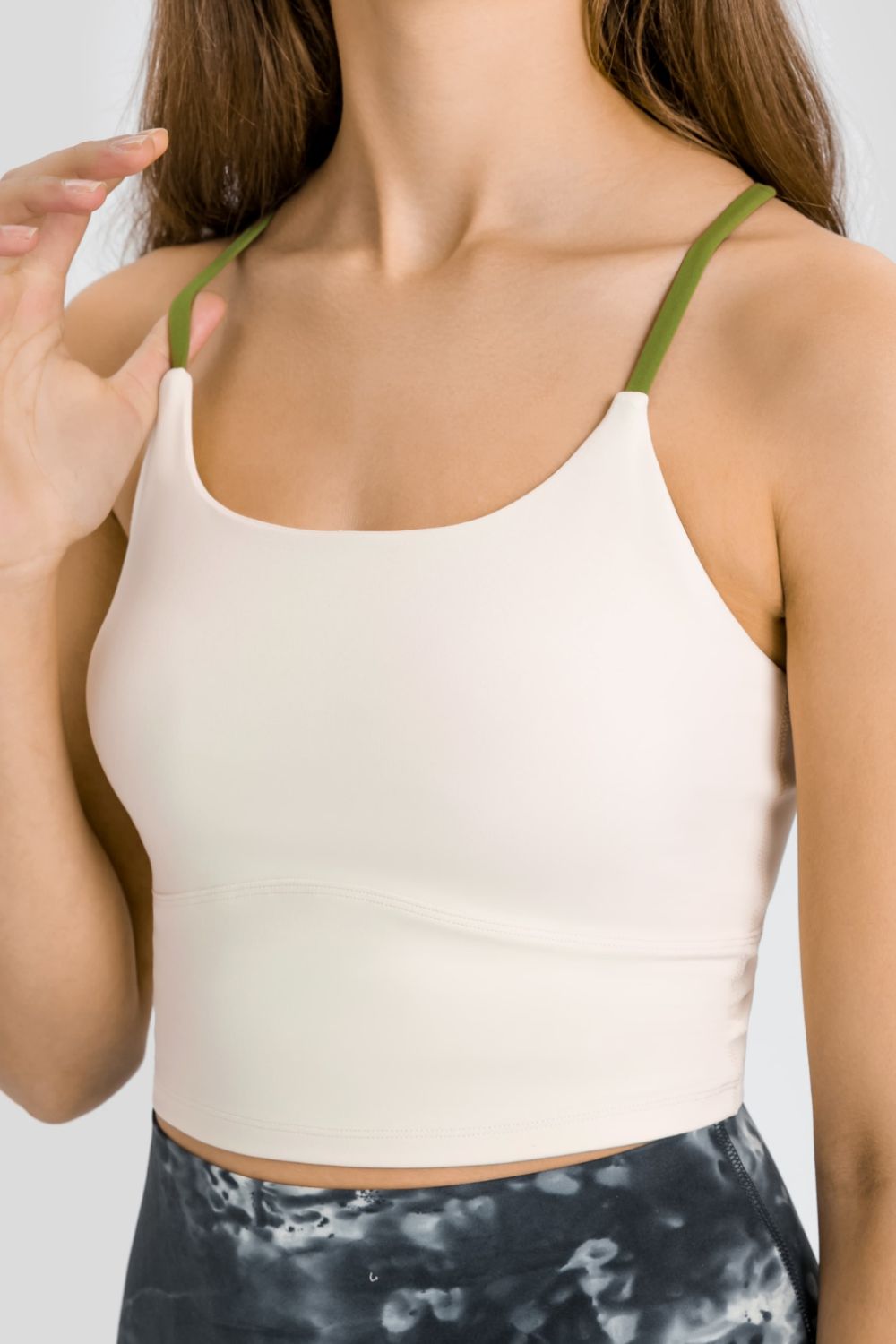 Light cream sports cami with scoop neck and green shoulder straps