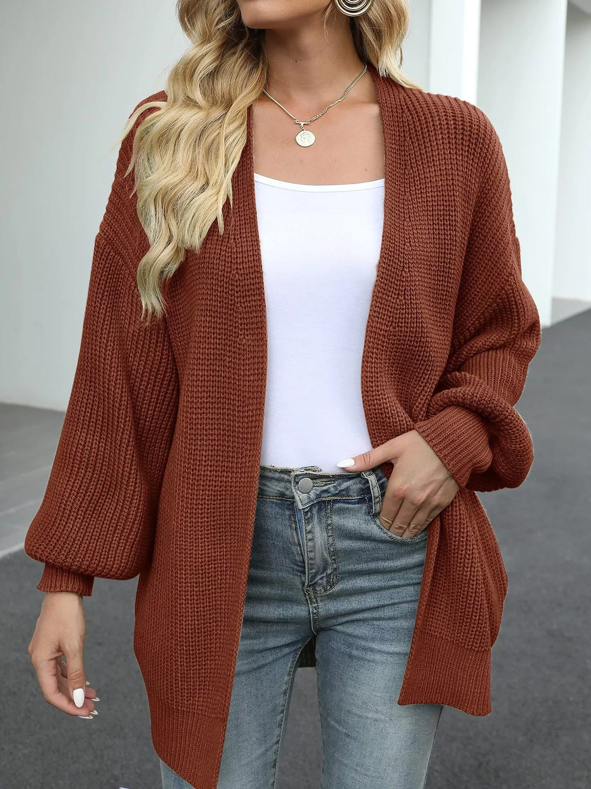 Rust brown waffle-knit open-front chunky cardigan with long sleeves and drape.