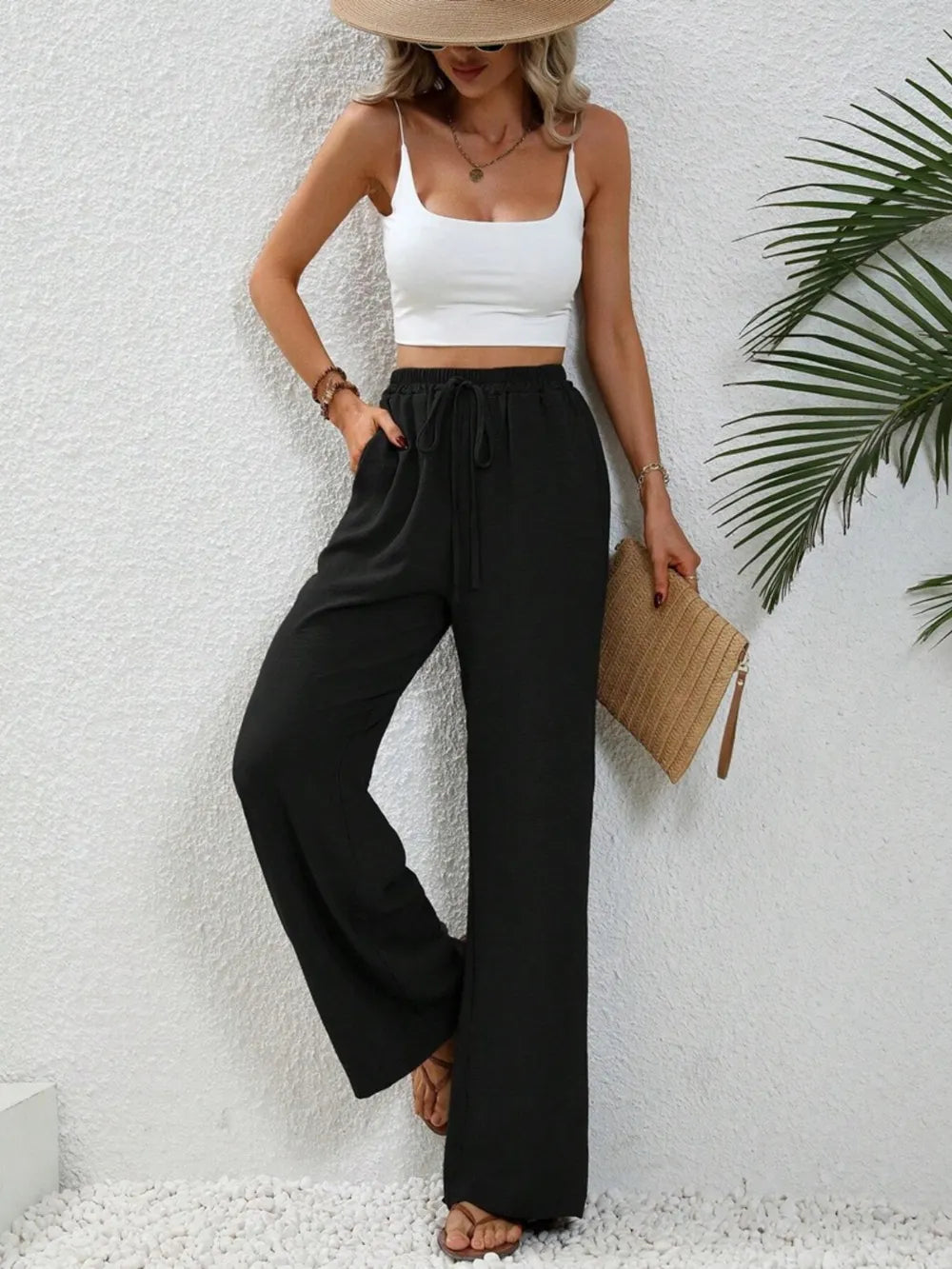 Black wide-leg drawstring pants with elastic waist and wide relaxed fit