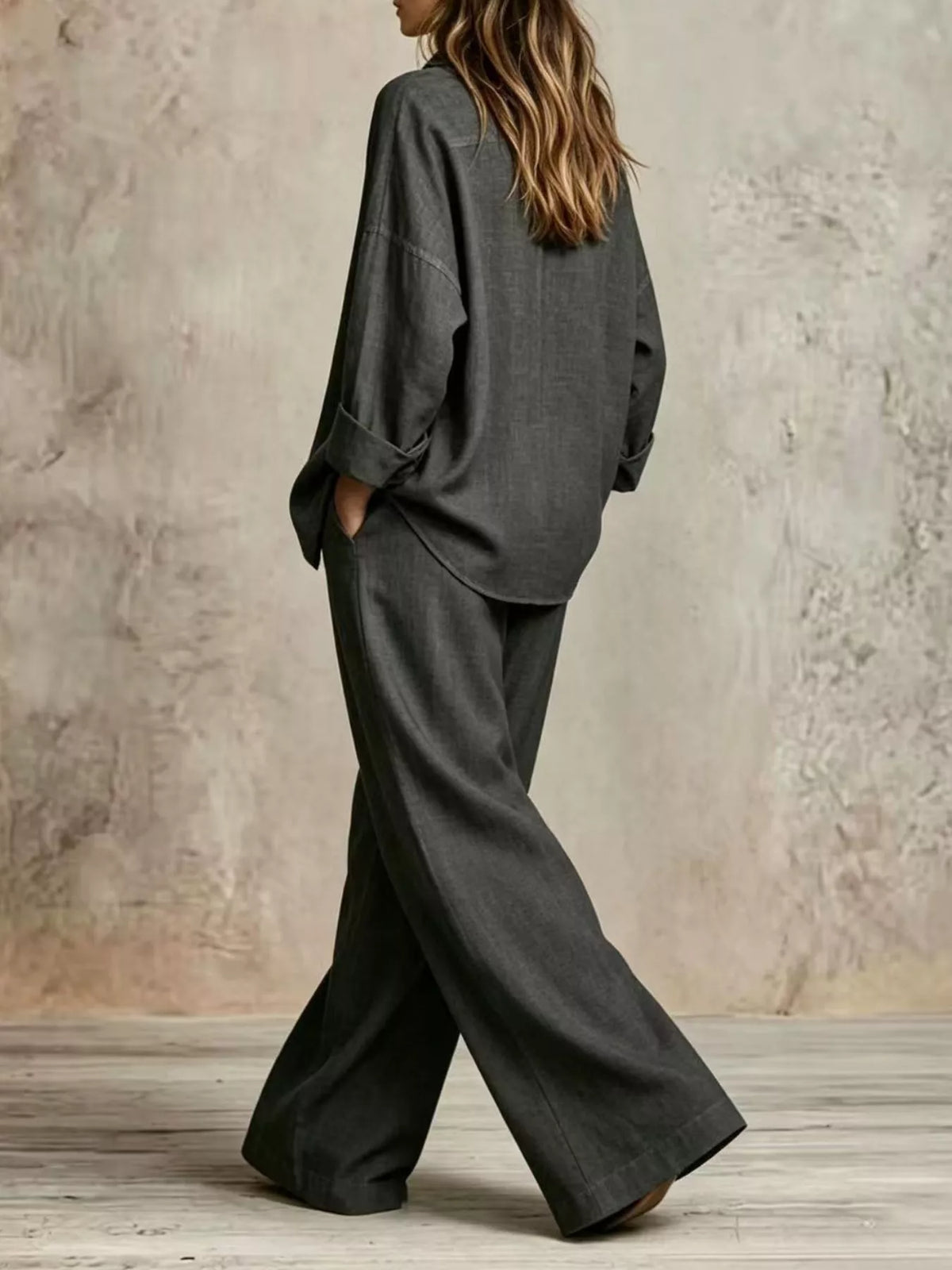 Gray wide-leg button shirt and pants set, back view, draped fabric, cuffed sleeves.