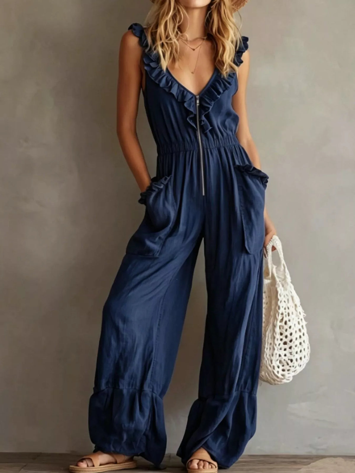 Navy blue ruffled V-neck sleeveless jumpsuit with tie front and wide-leg pockets