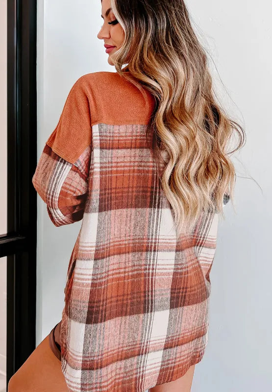Plaid button-up long sleeve jacket from the back with rust orange upper and plaid yoke