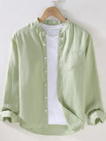 Men's long sleeve button-up shirt in light green with front buttons and chest pocket