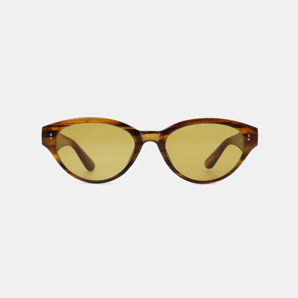Brown polycarbonate cat-eye sunglasses with yellow-tinted lenses and small stud details