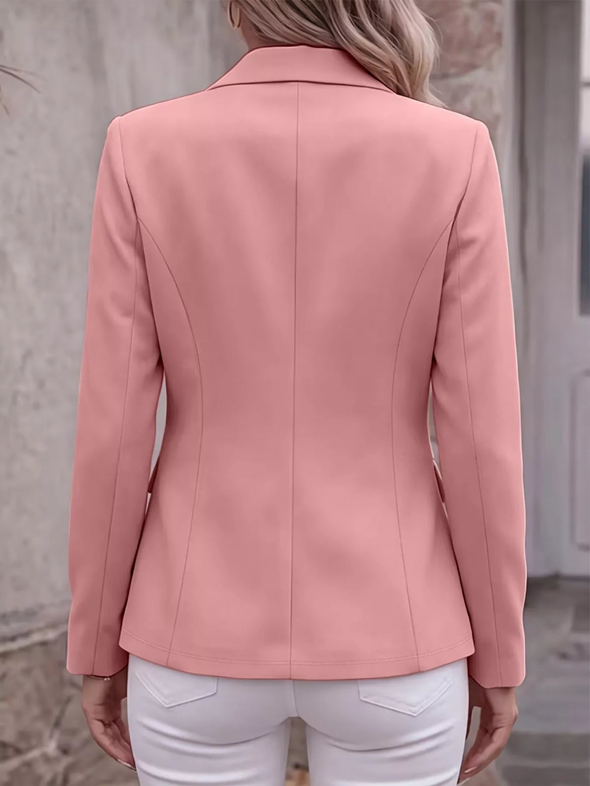 Back view of pink lapel long-sleeve blazer with tailored seams and shoulder lines