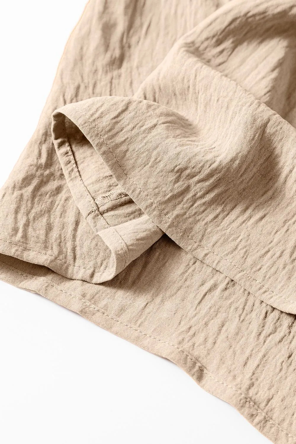 Khaki jumpsuit fabric with stitched pleat detail at cuff