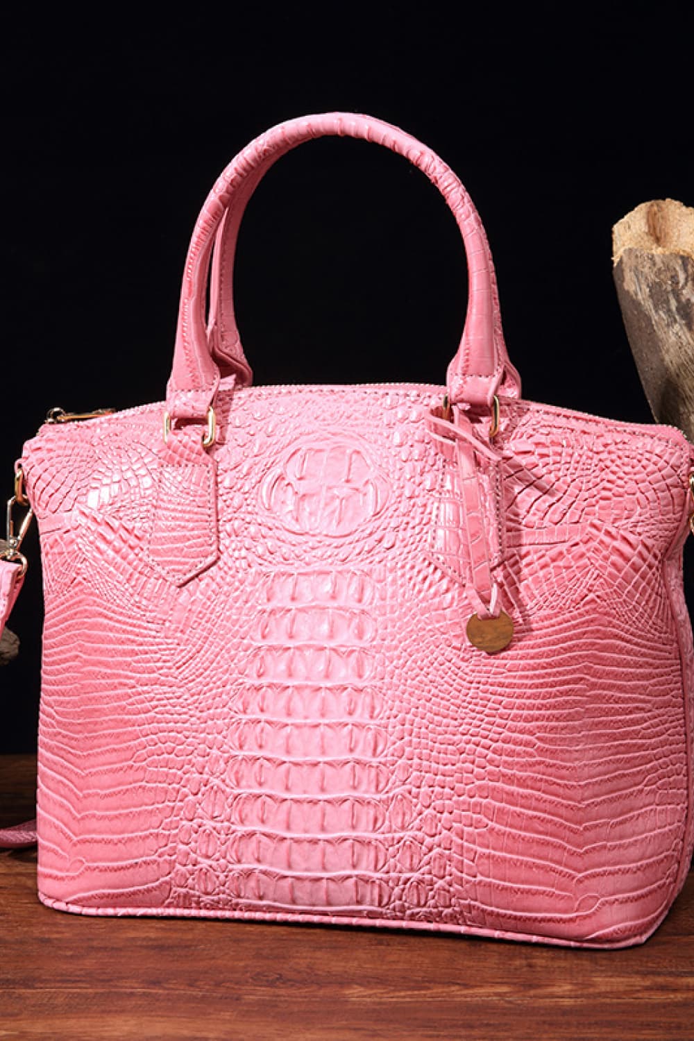 Vegan leather handbag in pink with structured top handles and embossed crocodile texture