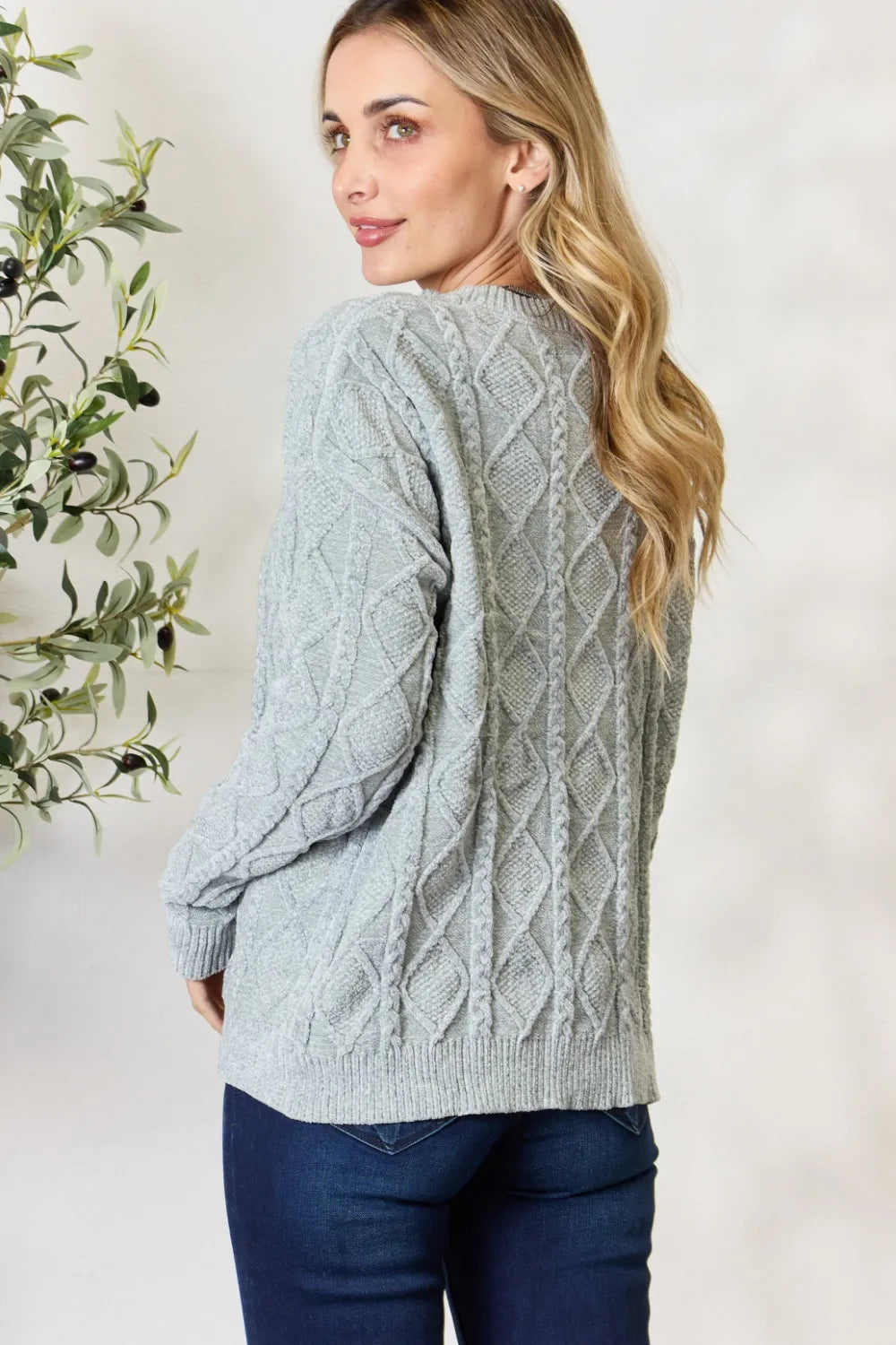 Dust sage cable knit round-neck sweater, side view showing long sleeves