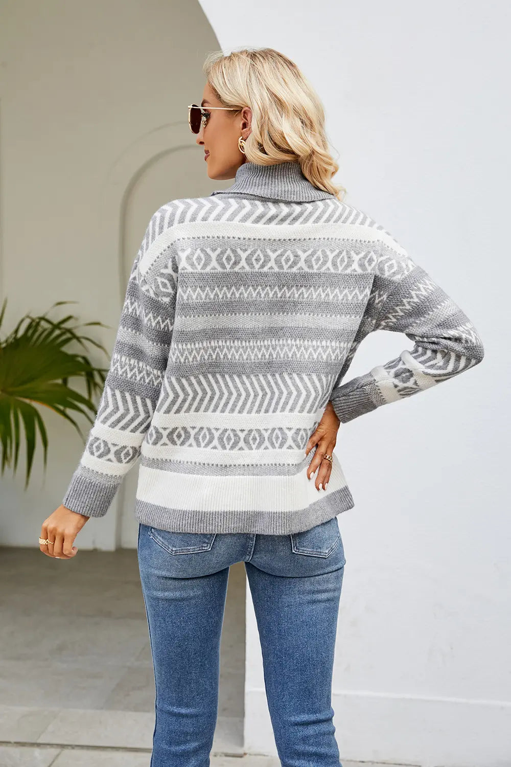 Geometric turtleneck sweater in light gray and white with long sleeves, back view