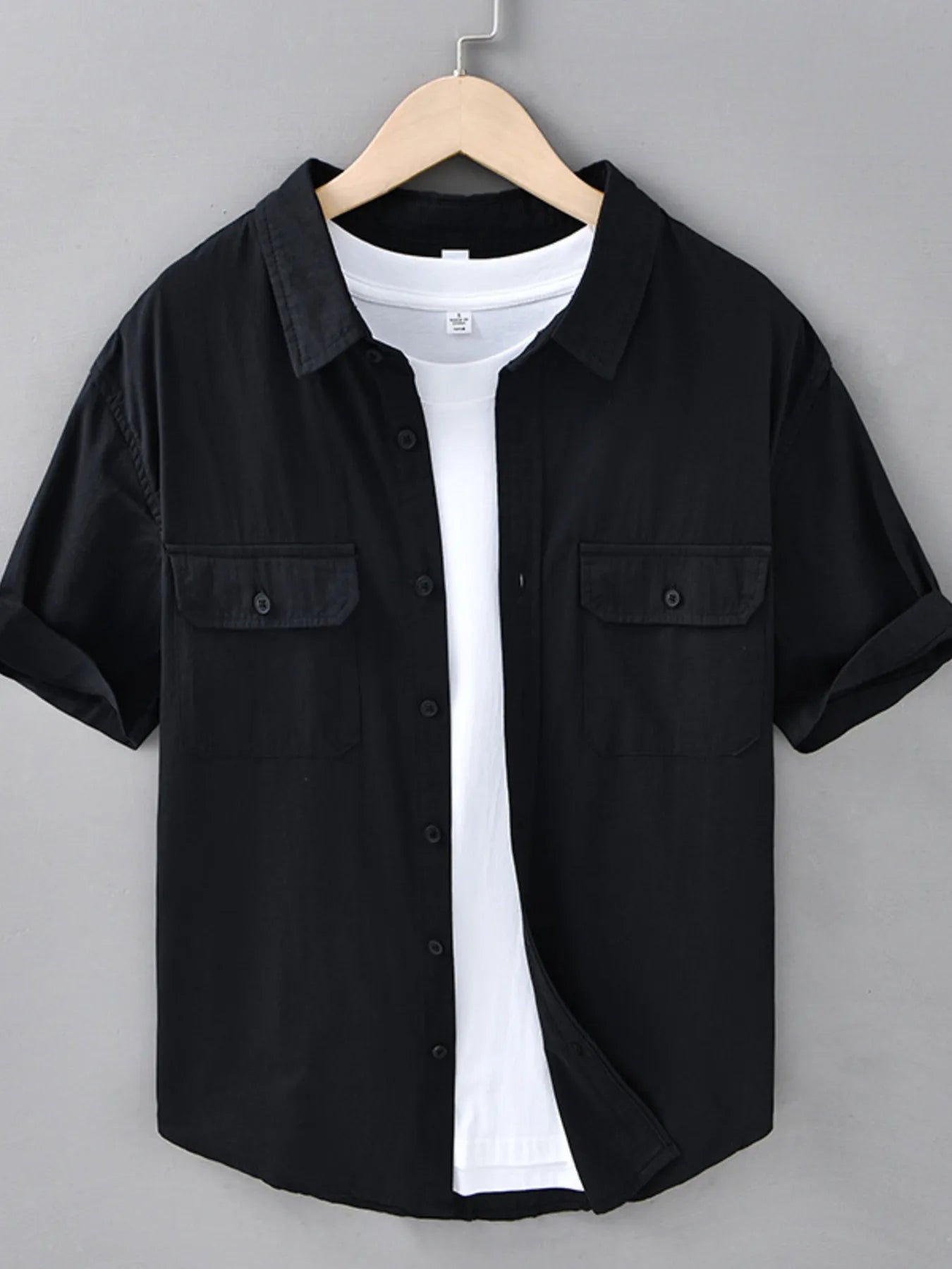 Black short-sleeve button-up shirt with chest flap pockets and front buttons